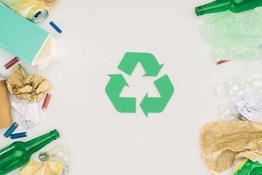 foto de simbolo de reciclaje con basura alrededor